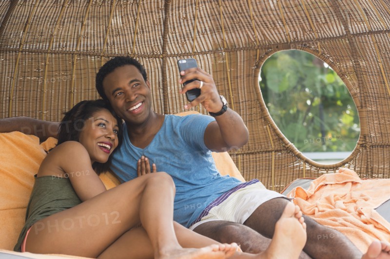 Couple taking selfie in cabana
