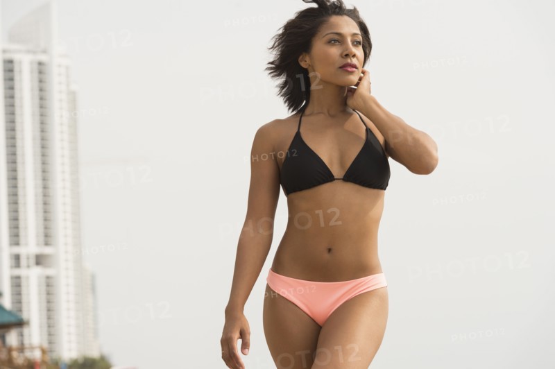 African American woman wearing bikini on beach
