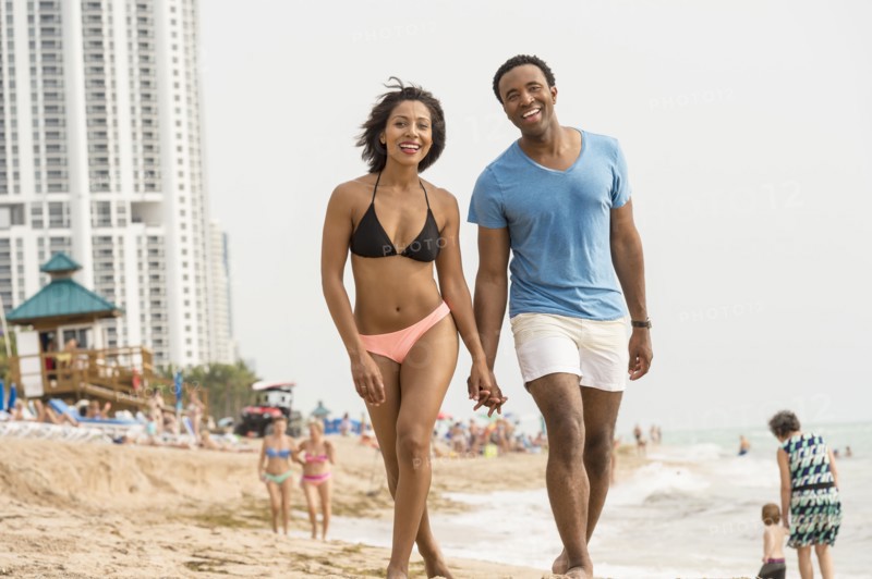 Couple holding hands on beach