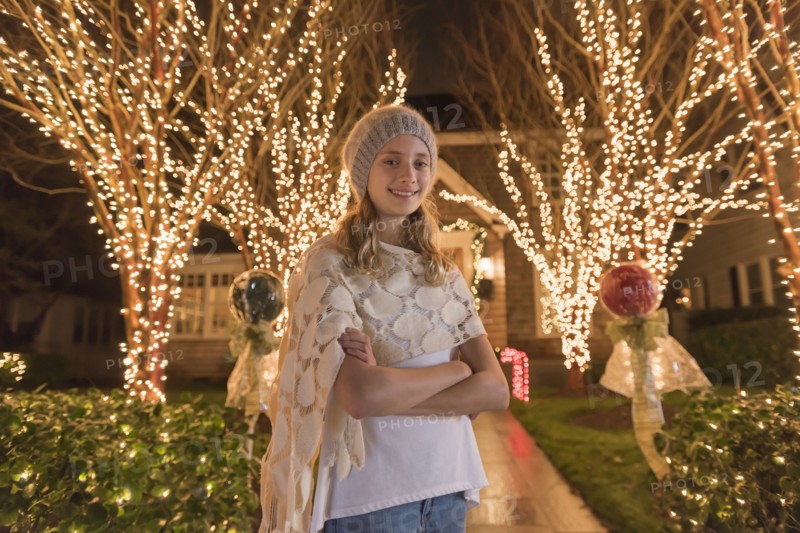 Caucasian girl posing near Christmas decorations in yard
