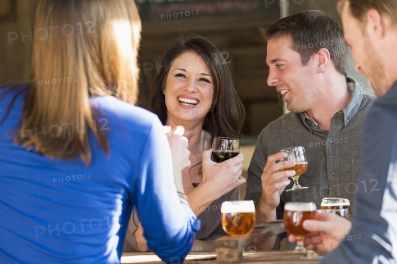 Caucasian friends drinking beer in brew pub