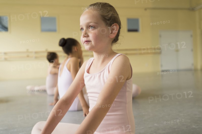 Girl sitting on floor of ballet studio