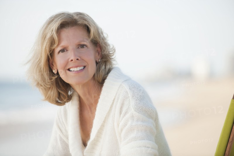 Caucasian woman sitting on beach