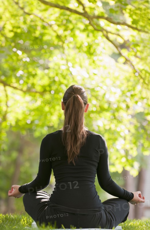 Caucasian woman practicing yoga in park