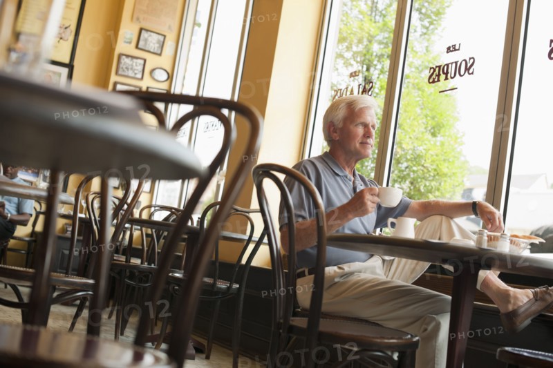 Caucasian man drinking coffee in restaurant
