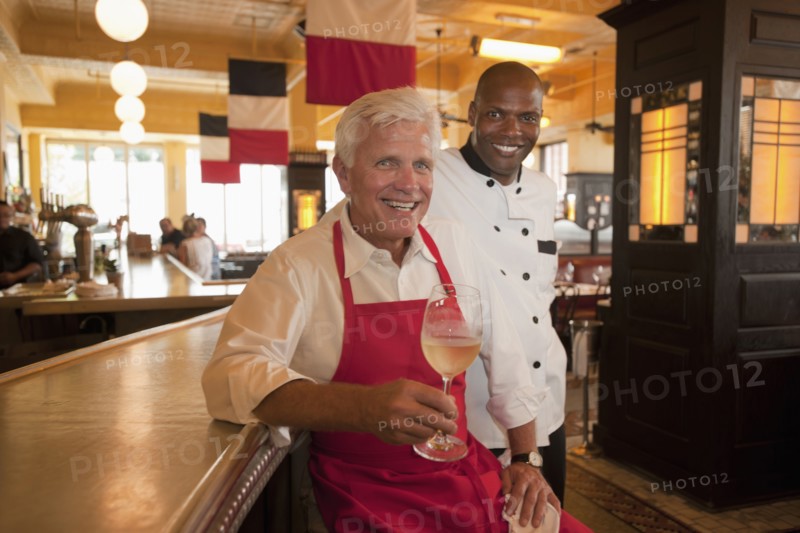 Smiling restaurant waiter and chef