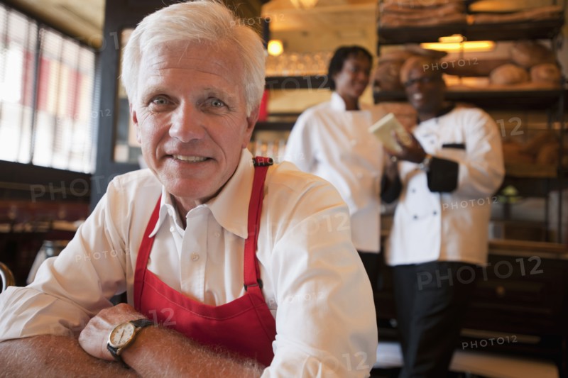 Caucasian waiter sitting in restaurant