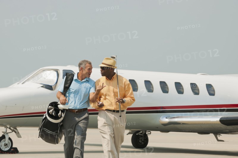Golfers walking on airport tarmac