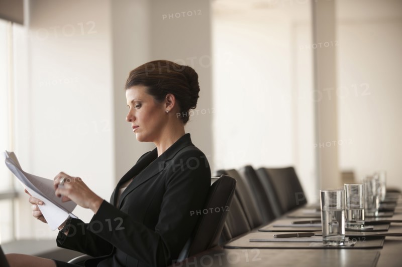 Caucasian business woman working in conference room