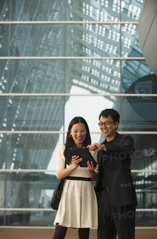 Asian business people using digital tablet