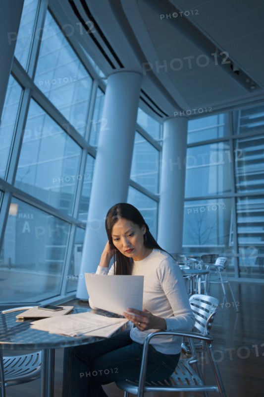Asian businesswoman looking at paperwork