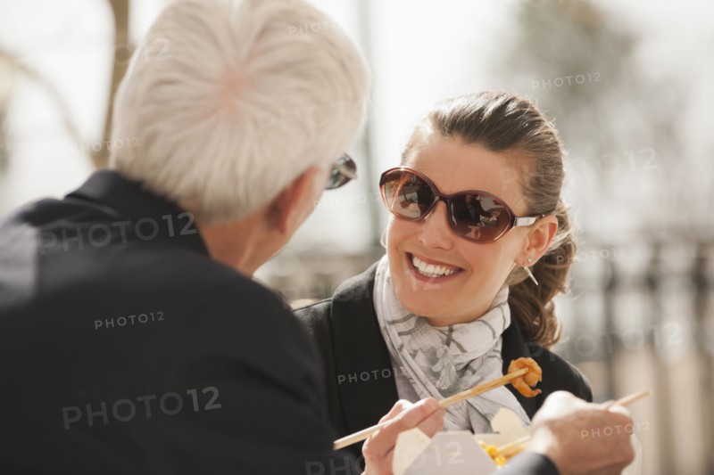 Caucasian business people eating Asian food
