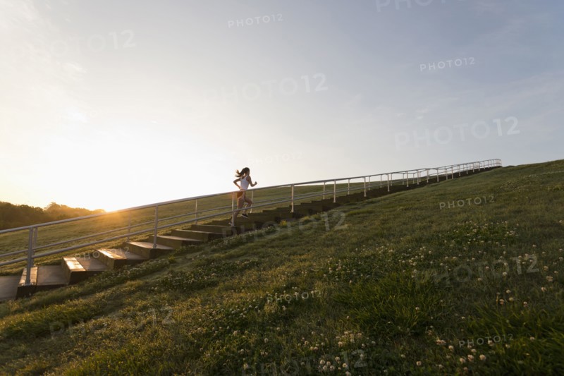 Caucasian woman running up steps
