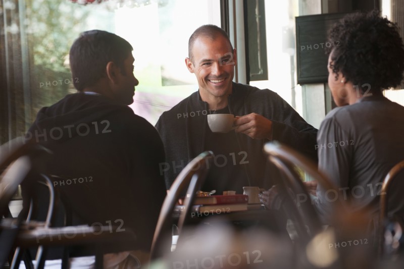 Friends sitting together in cafe