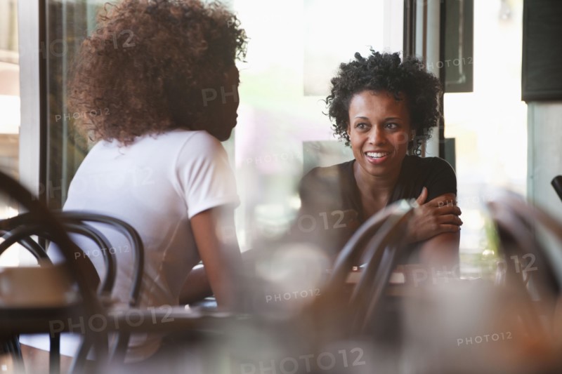 Black friends sitting together in cafe