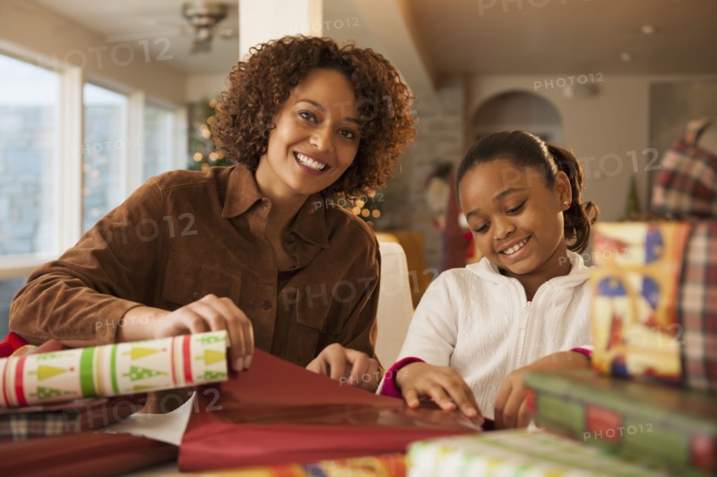 Mother and daughter wrapping Christmas presents