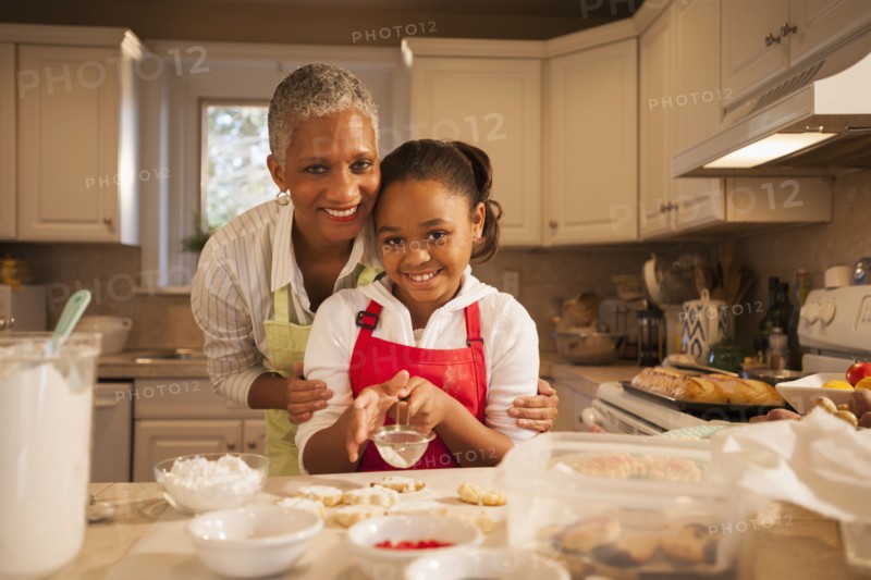 Woman and granddaughter baking in kitchen