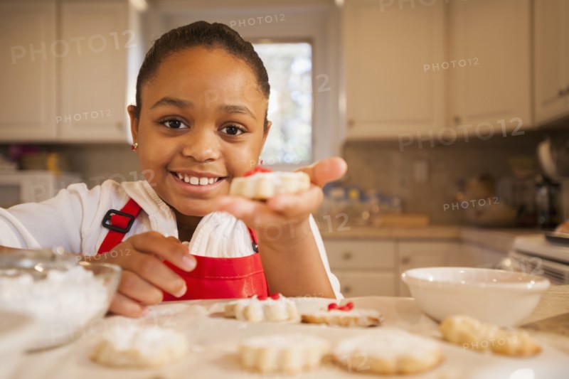 African American girl baking in kitchen