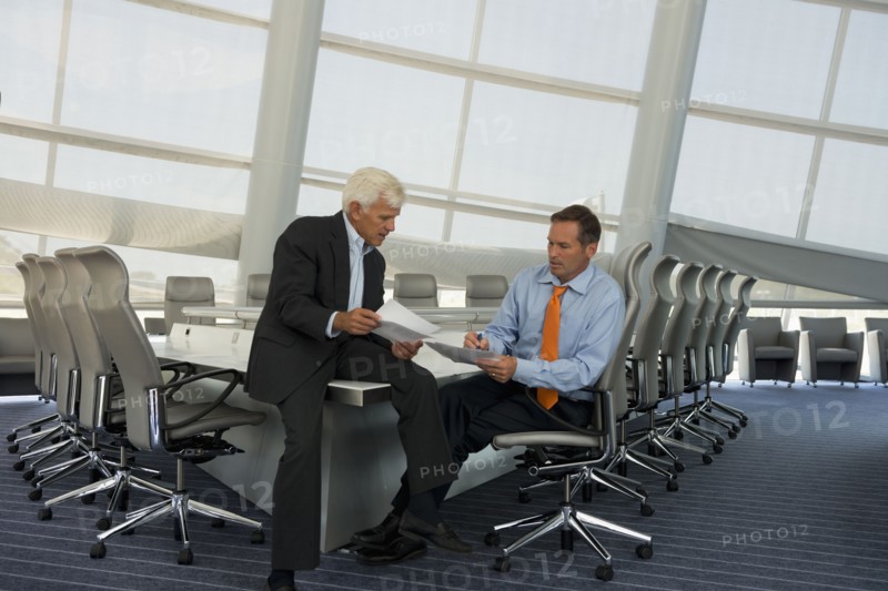 Caucasian businessmen talking in conference room