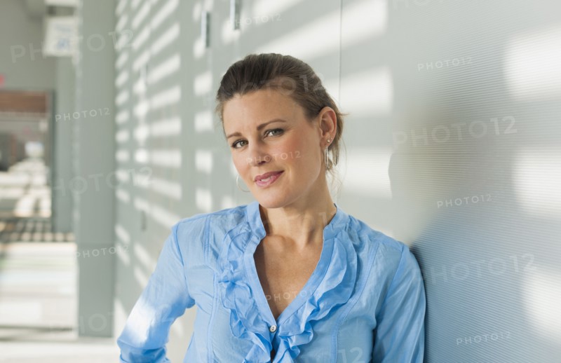Caucasian businesswoman smiling in office