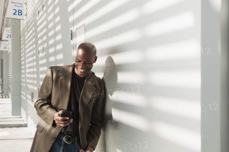 African American businessman using cell phone in office
