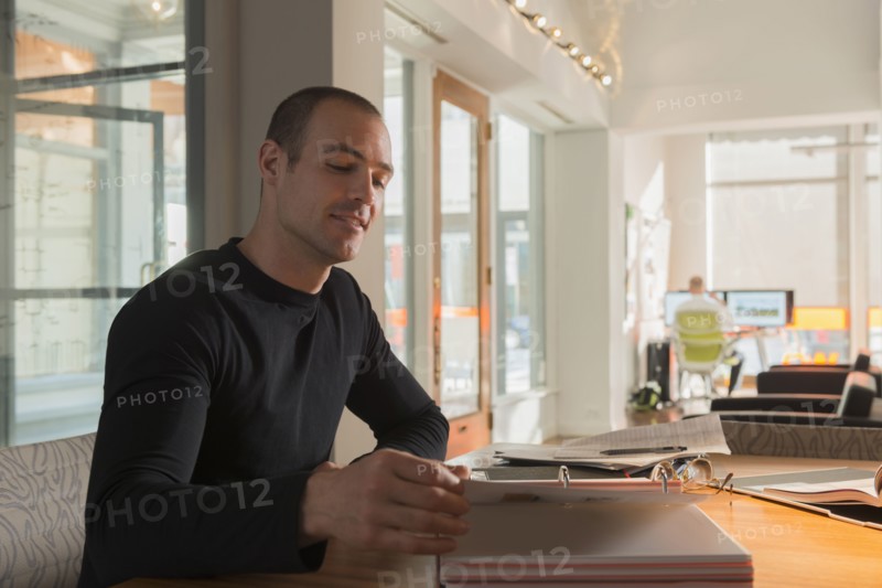 Caucasian businessman reading at desk