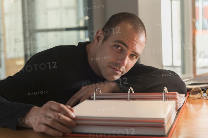 Caucasian businessman reading at desk