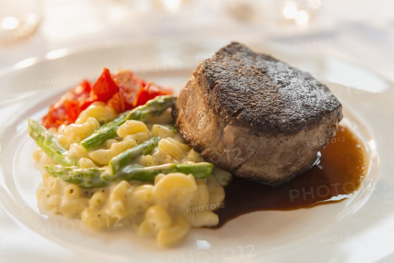 Plate of seared meat with vegetables and pasta