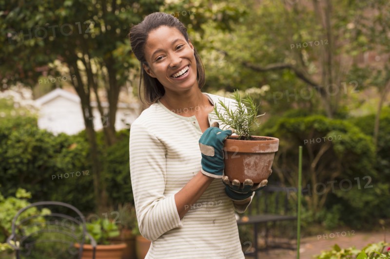 African American woman gardening in backyard