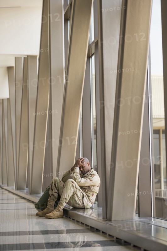 African American soldier sitting in airport
