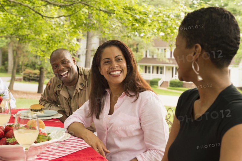 African American man and women laughing at picnic