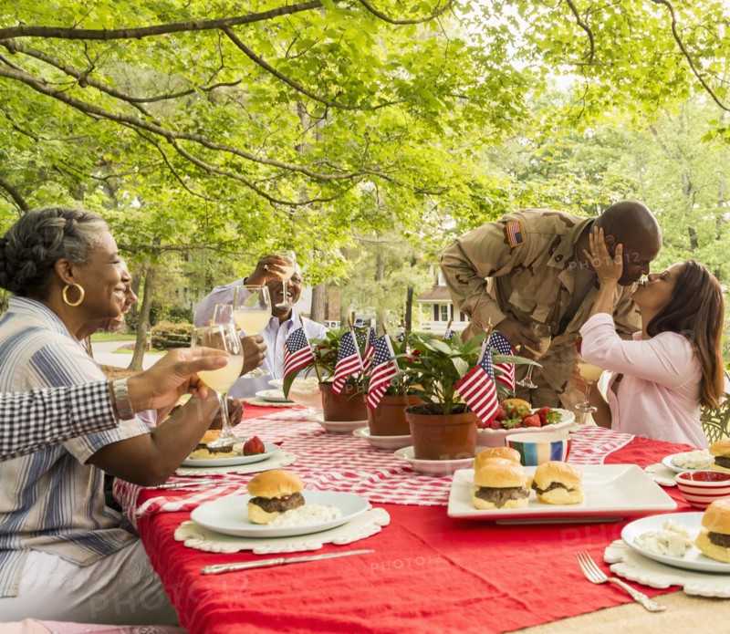 Soldier man kissing wife at picnic