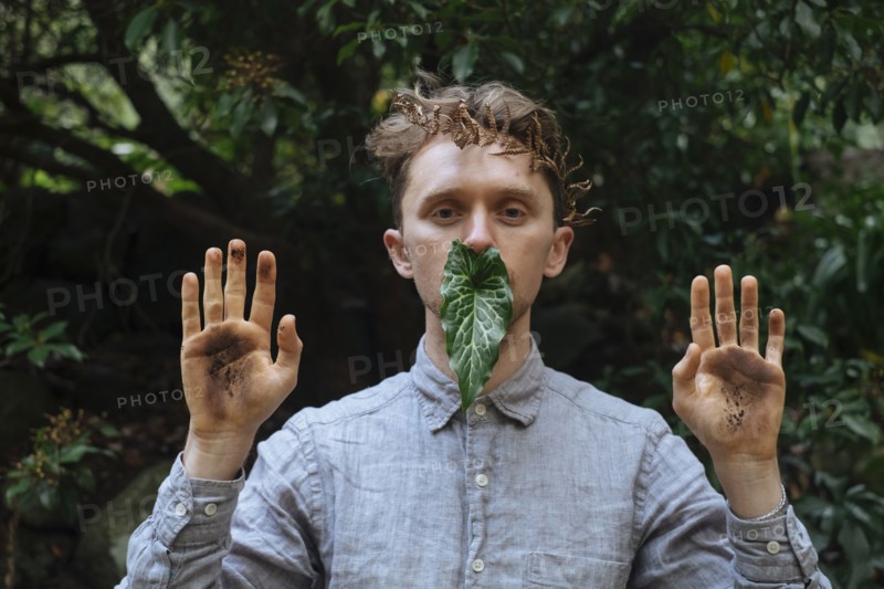 Caucasian man with dirty hands and leaf