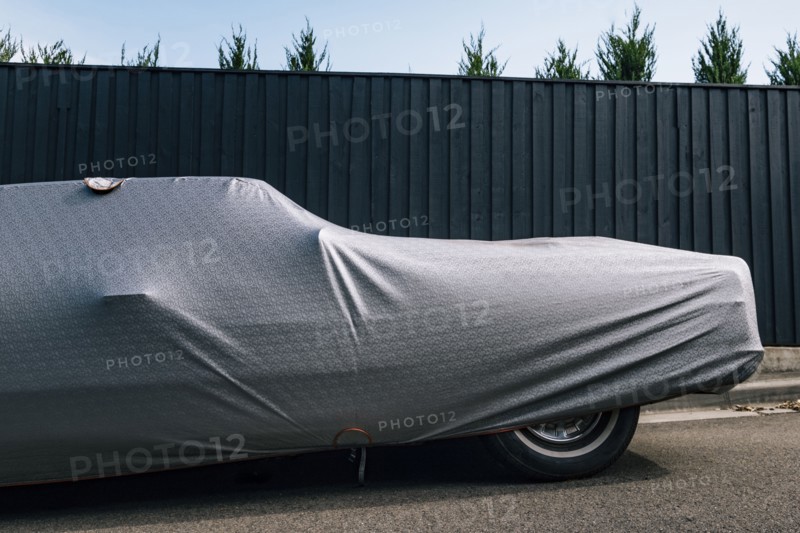 Protective cover on car near fence