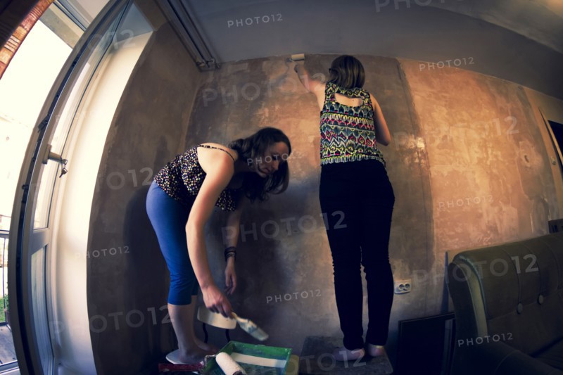 Women painting wall