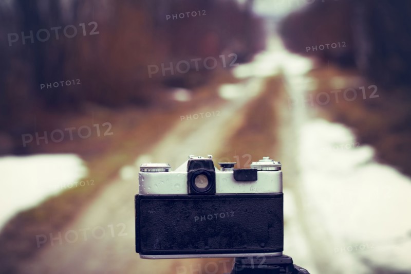 Close up of camera on tripod on snowy road
