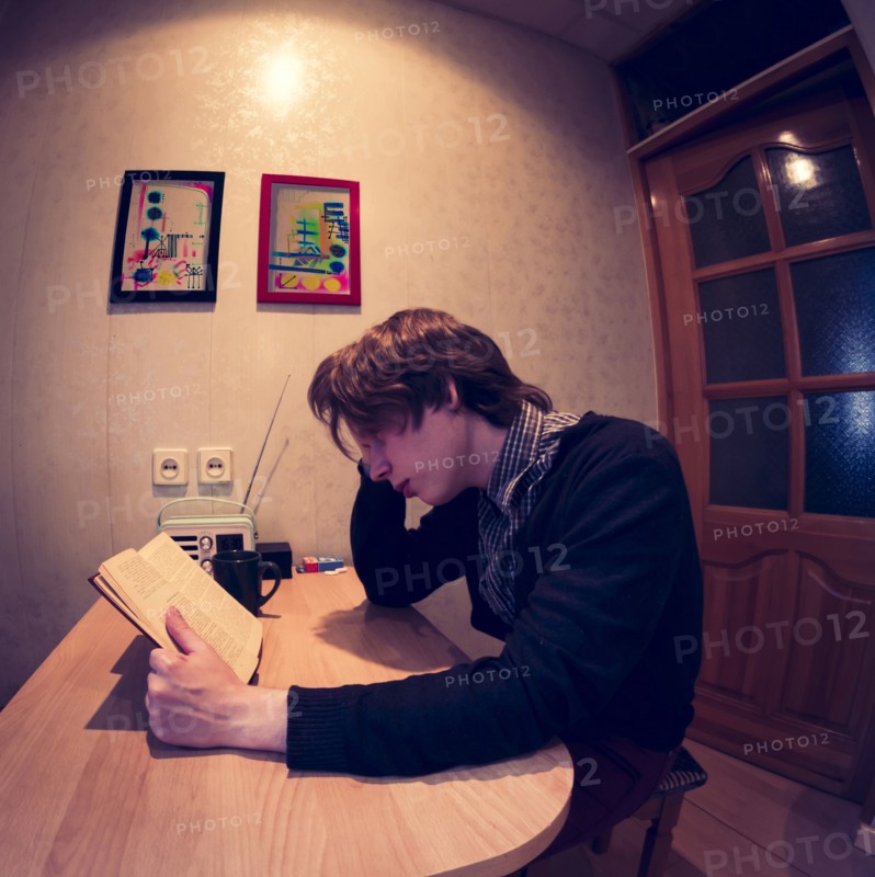 Caucasian man reading at table