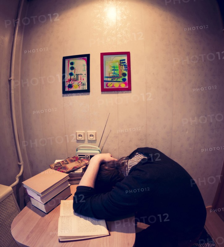 Caucasian student sleeping at table