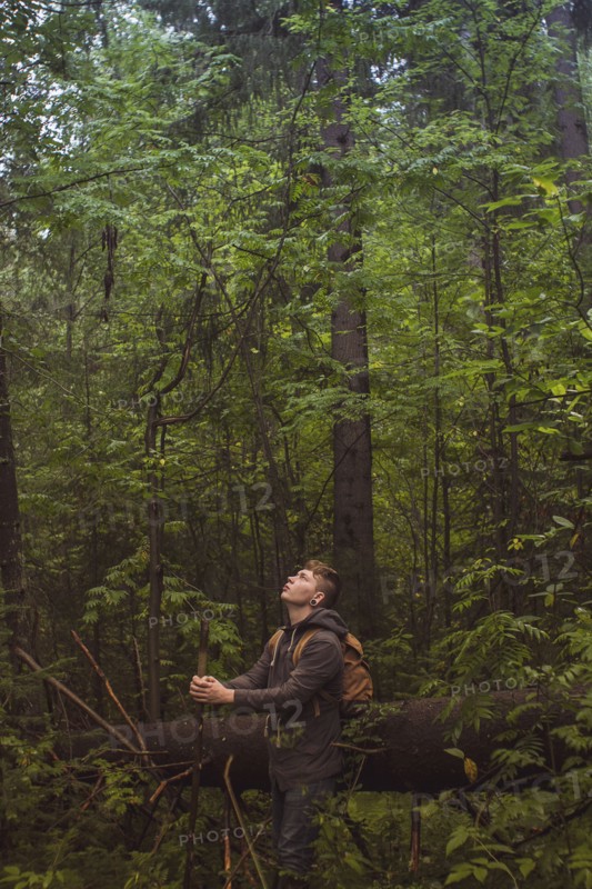 Caucasian man walking in forest