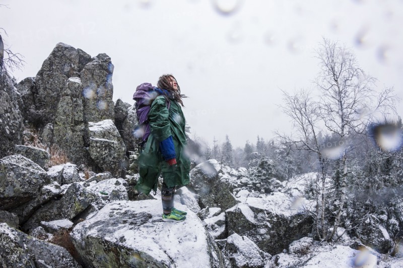 Caucasian hiker standing on rocky hillside