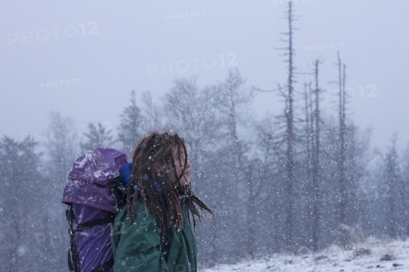 Caucasian hiker walking in snow