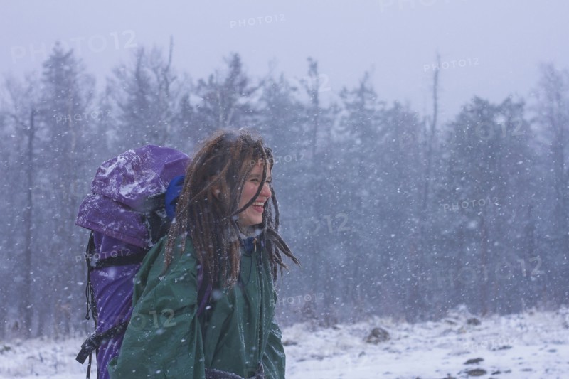 Caucasian hiker walking in snow