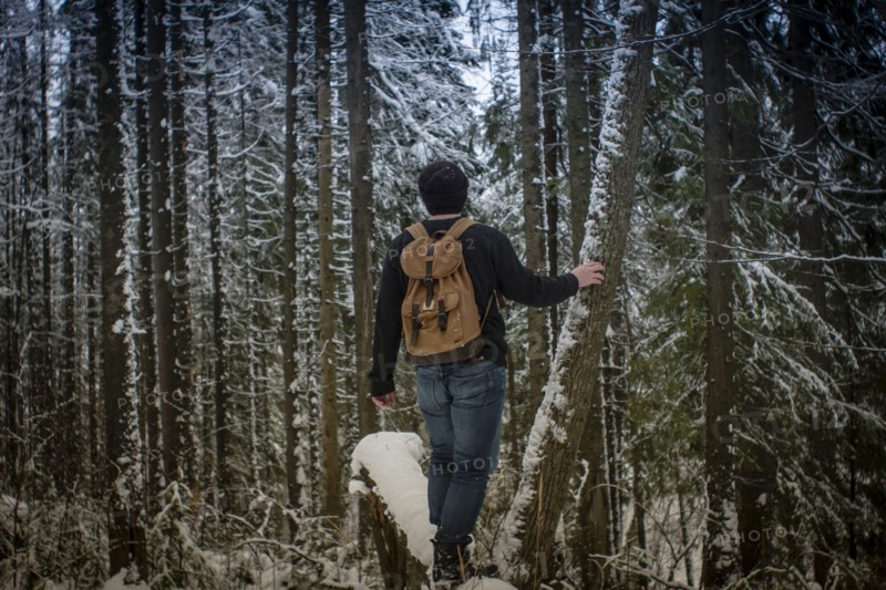 Caucasian hiker standing in snowy forest