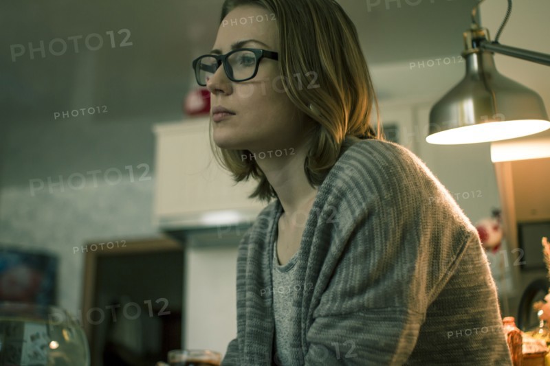 Serious Caucasian woman sitting indoors