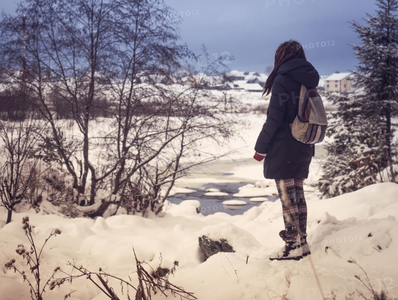Caucasian woman admiring snowy rural scene
