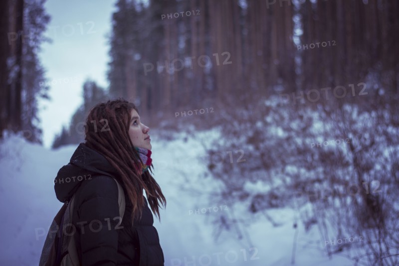 Caucasian woman standing in snowy forest