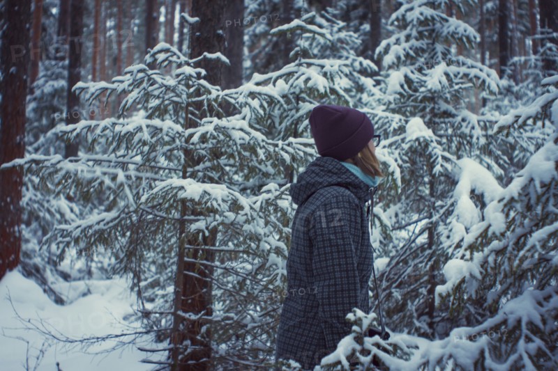 Caucasian woman standing in snowy forest