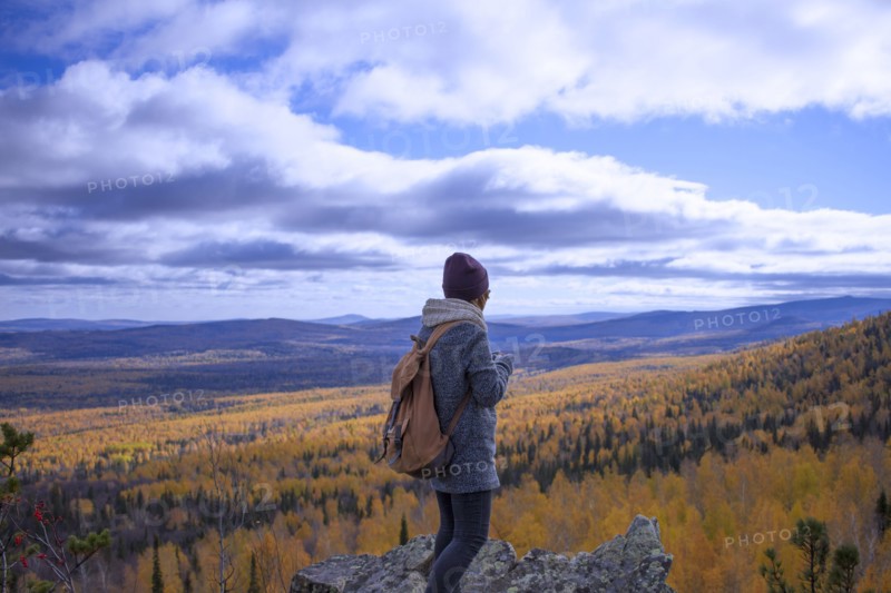Caucasian woman backpacking in autumn landscape