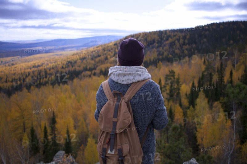 Caucasian woman backpacking in autumn landscape