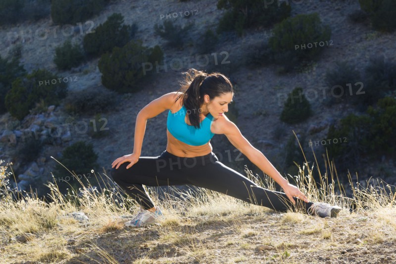 Hispanic woman stretching before exercise